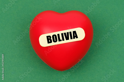 On a green surface lies a red heart with the inscription - Bolivia