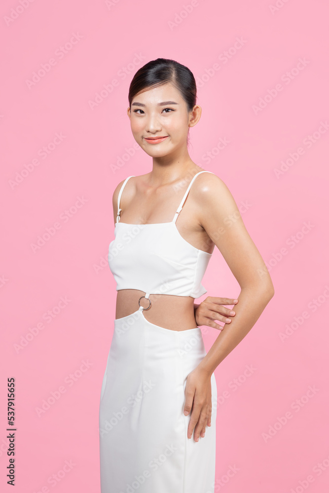 Beautiful woman model posing in white dress in the studio Beautiful woman model posing in white dress in the studio