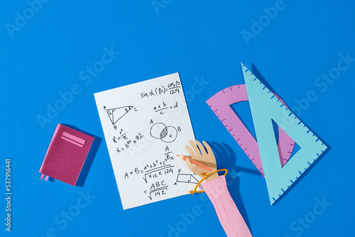 Math school supplies on wooden table in math class photo