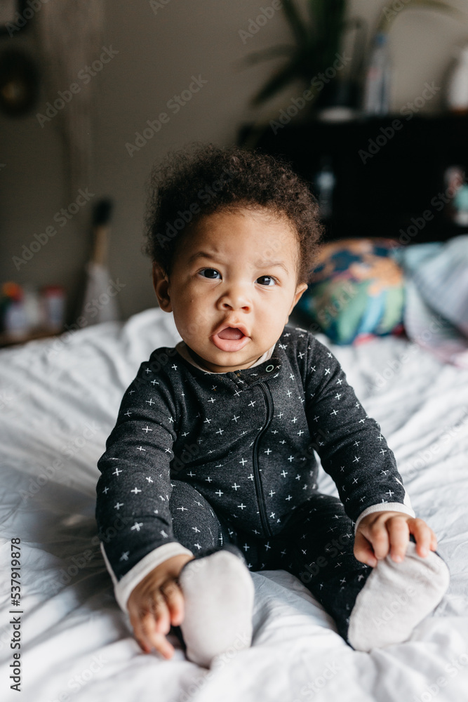 A 7 month old baby playing on the bed A 7 month old baby playing on the bed