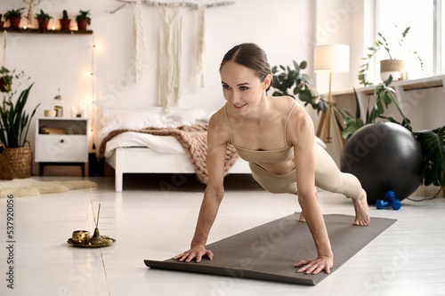woman doing yoga position at home photo