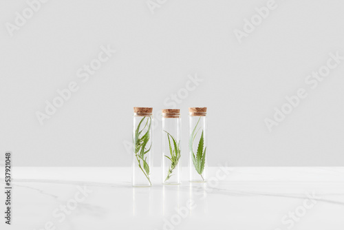 Natural cannabis leaves in glass bottles. photo