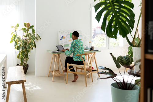 African woman working in her nice apartment photo