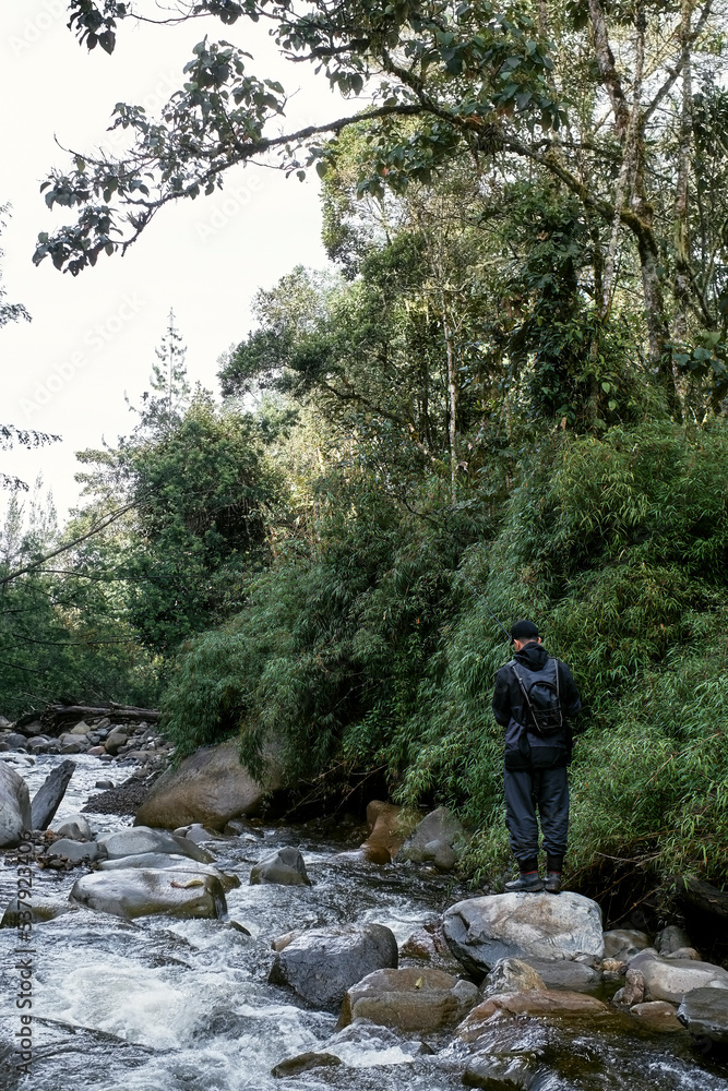 Back view of fisherman on the river