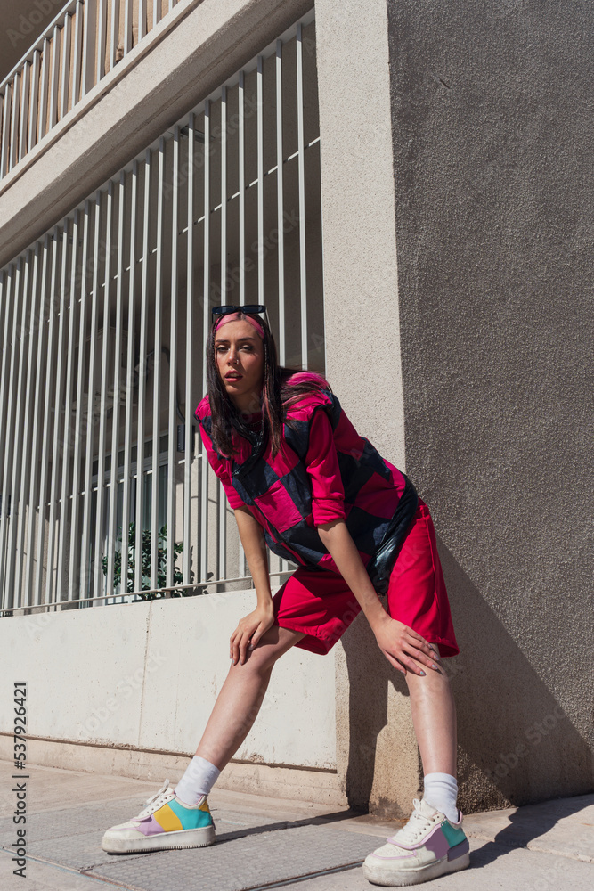 Young woman at the street in city. Pink outfit Young woman at the street in city. Pink outfit