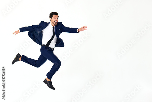 Man business smile with teeth in costume running and jumping flying up open mouth happiness and surprise full-length on white isolated background copy space 
