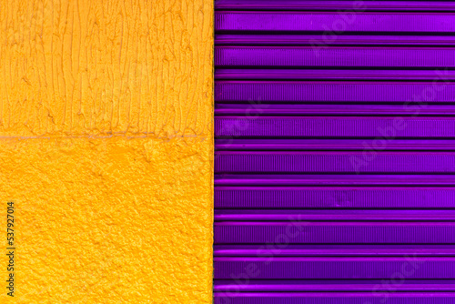 texture pattern of purpple iron door of closed store and yellow wall in Brazil photo