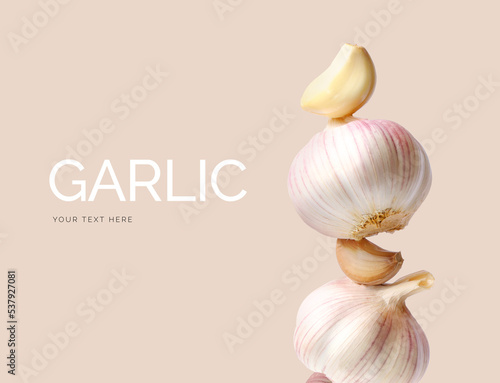 Creative layout made of garlic on the beige background. Flat lay. Food concept. Macro concept. 
