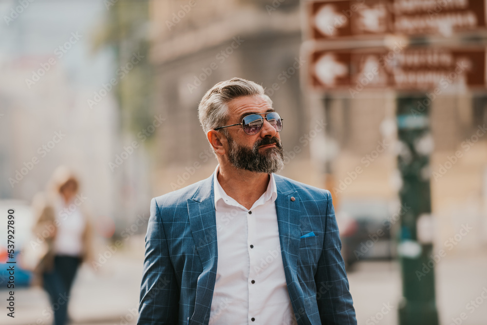 Fototapeta premium Modern senior businessman with a bag exits modern corporation