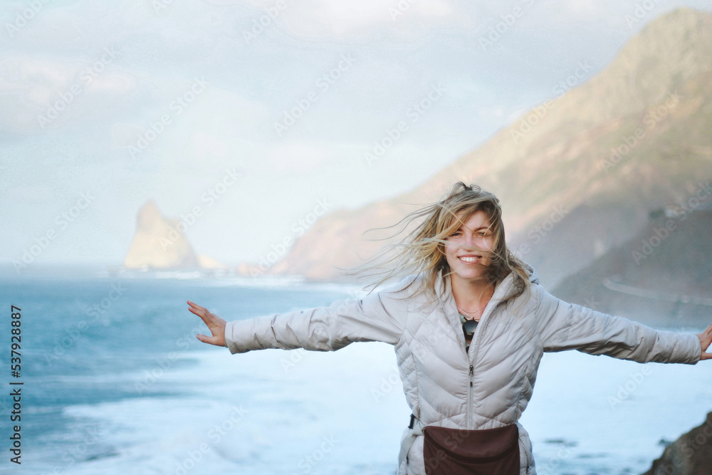 Happy woman with flying hair enjoying freedom near sea Happy woman with flying hair enjoying freedom near sea