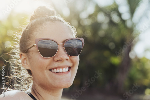 Portrait of a woman wearing glasses outdoors photo