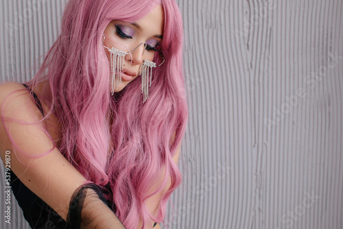 Beautiful woman with pink hair looking down