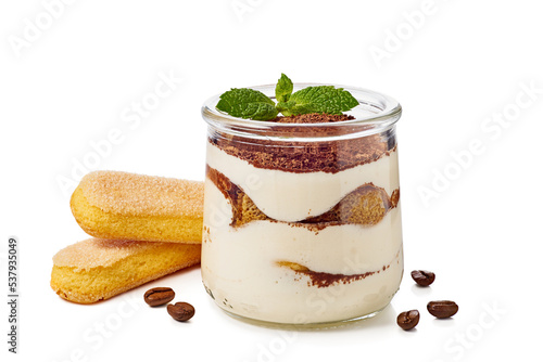 Jar with layered tiramisu cake and savoyardy cookies on white