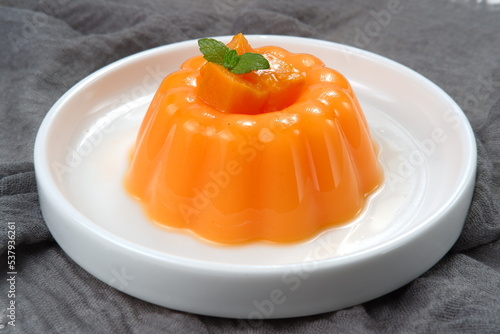 Mango pudding, jelly, dessert on white plate.