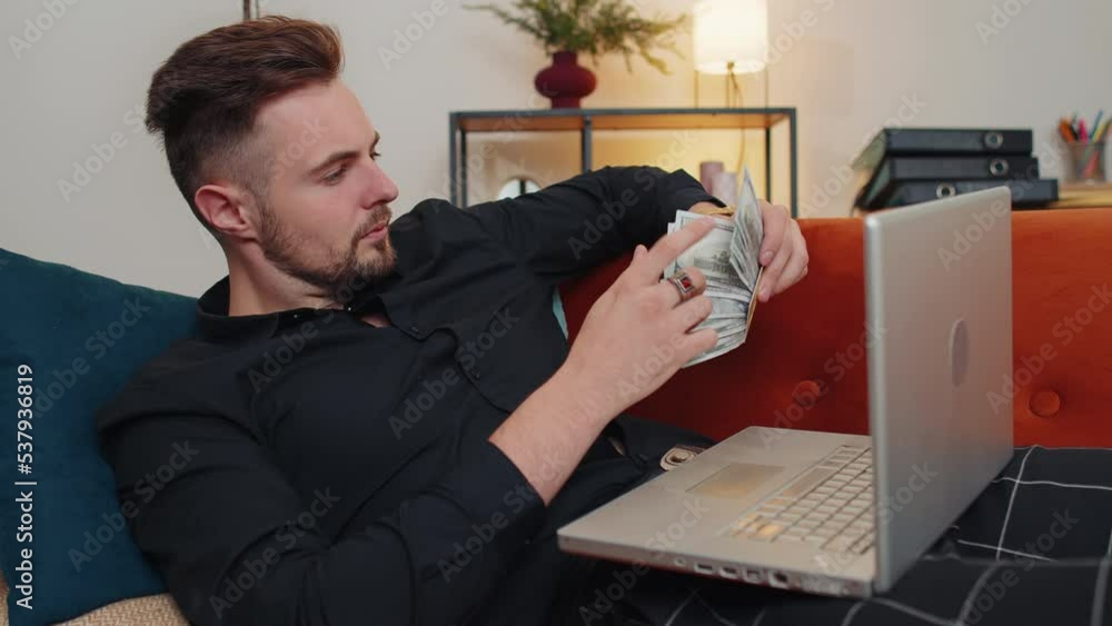 Man using credit bank card and laptop computer while transferring money ...