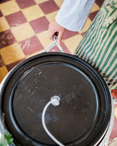 Hands closing a plastic barrel photo