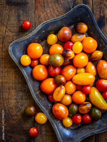 Colorful Heirloom Tomatoes on a rectangular metal dish photo