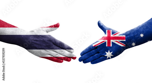 Handshake between Australia and Thailand flags painted on hands, isolated transparent image.