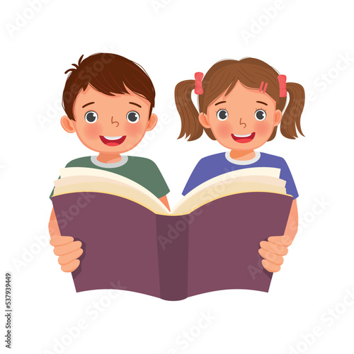 Cute little kids boy and girl holding big book reading together