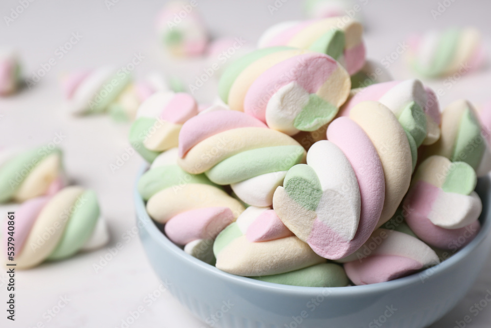 Bowl with colorful marshmallows on white table, closeup Bowl with colorful marshmallows on white table, closeup