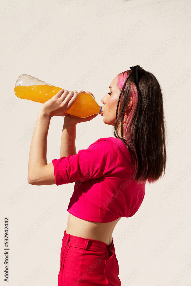 Attractive girl drinking orange juice outdoors Attractive girl drinking orange juice outdoors