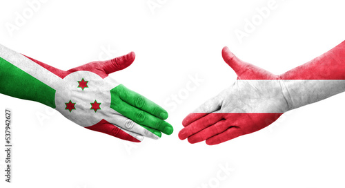 Handshake between Austria and Burundi flags painted on hands, isolated transparent image.
