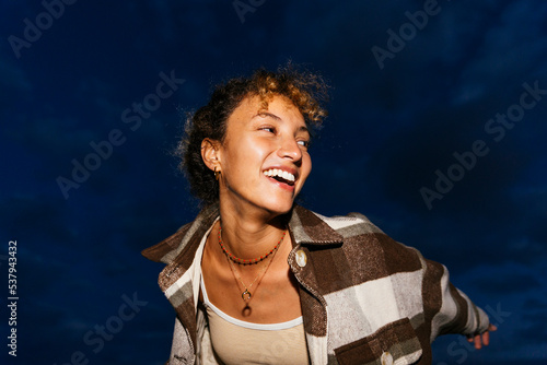 Smiling woman lit by flash