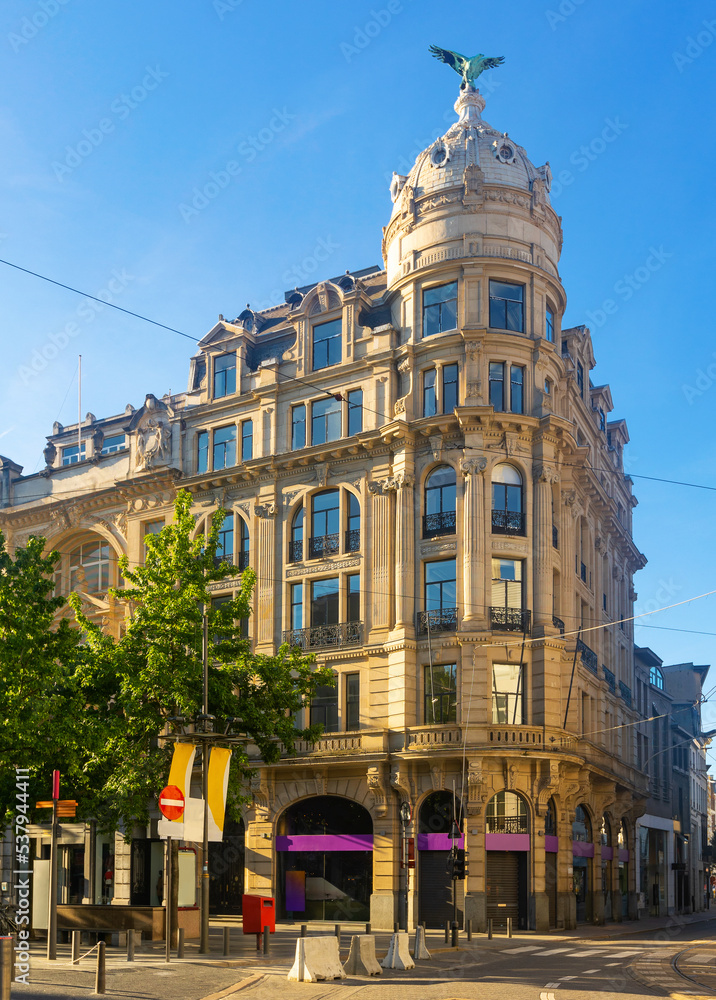 Fototapeta premium Scenic view of Antwerp summer cityscape overlooking monumental baroque office building crowned with a dome and eagle sculpture on corner of Meir and Huidevettersstraat streets, Belgium.