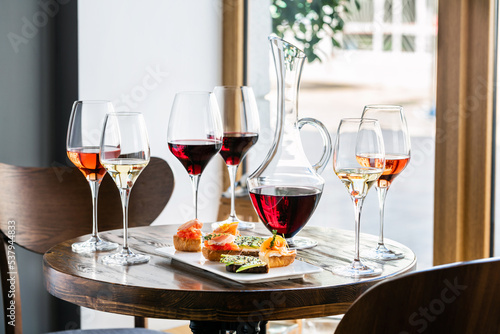 Various wines served in elegant goblets and decanter