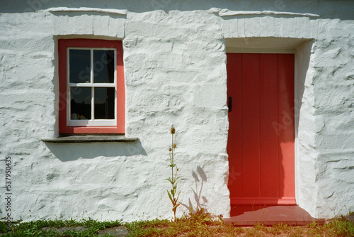 Traditional Welsh cottage with a red door