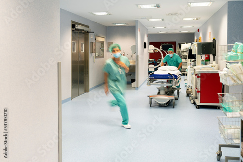 Doctor And Nurse Pulling Stretcher In Hospital