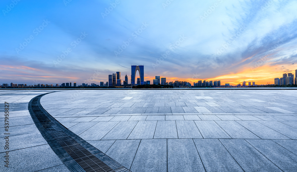 Cityscape of Suzhou City, Jiangsu Province, China. Empty square floor and city skyline at sunset.