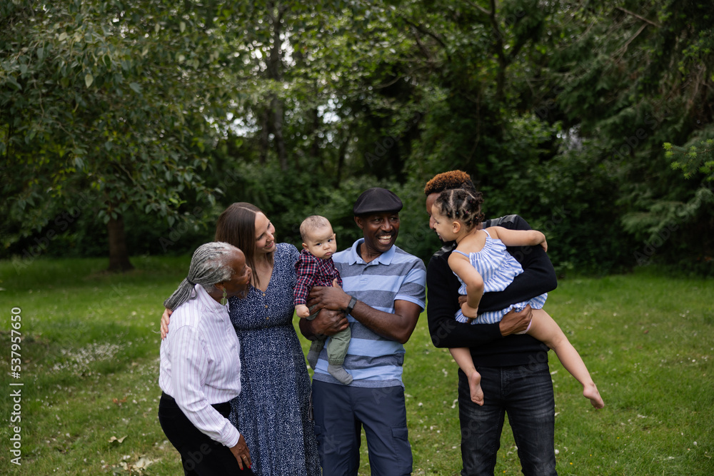 Extended family in the park together for family portraits. Extended family in the park together for family portraits.
