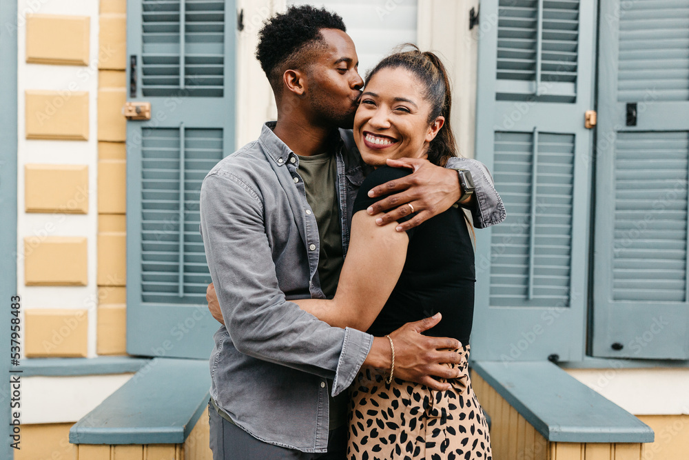 © Kristen Curette & Daemaine Hines/Stocksy - A black couple walking on the sidewalk