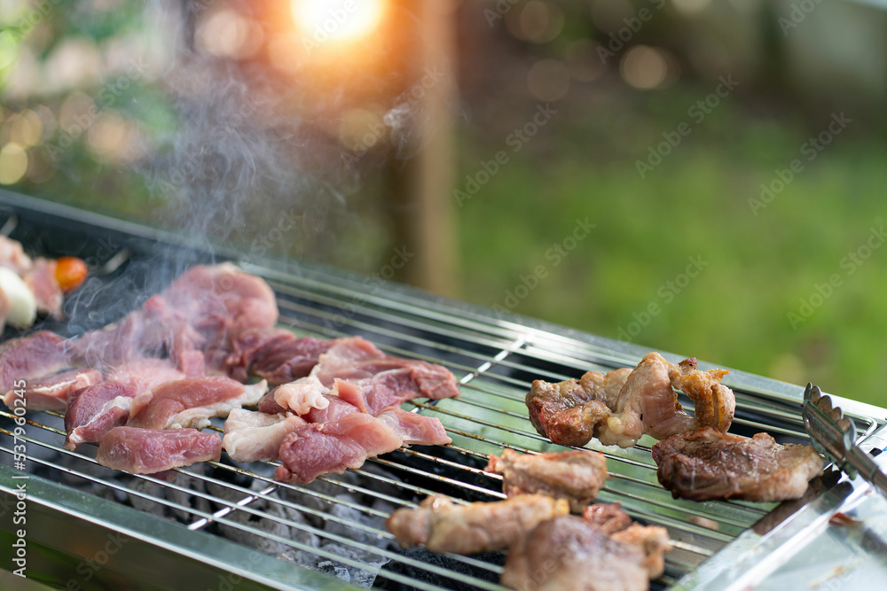 barbecue party food summer grilled meat Happy friends are having fun grilling meat, enjoying a barbecue party and beer celebration concept
