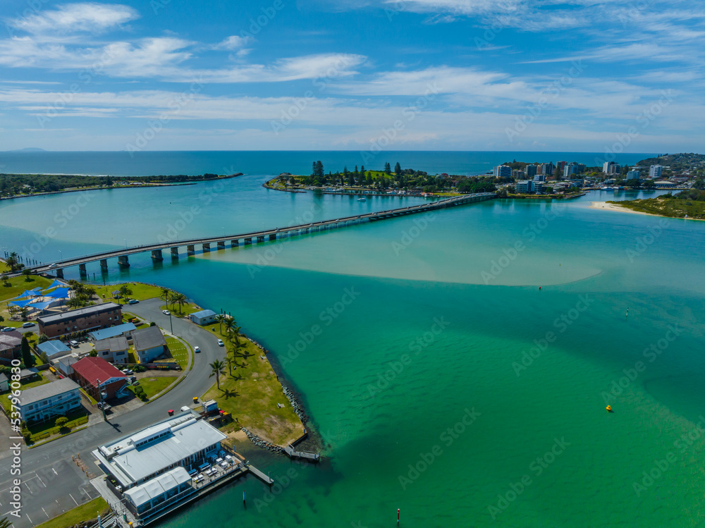 Fototapeta premium Bridge between two towns daytime waterscape