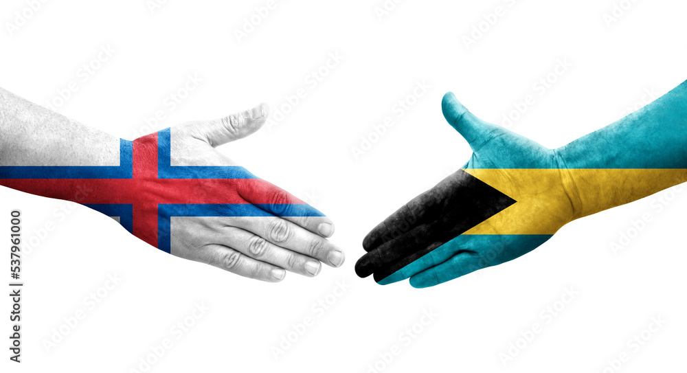 Handshake between Bahamas and Faroe Islands flags painted on hands, isolated transparent image. Handshake between Bahamas and Faroe Islands flags painted on hands, isolated transparent image.