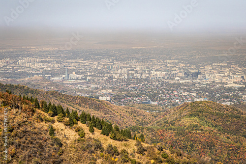 Mountain landscape with a view of the city of Almaty and the visible smog. Almaty air pollution concept