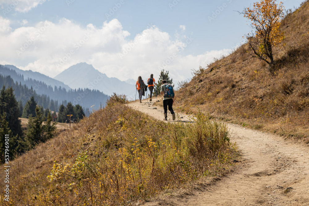Young hikers walking in the mountains in Autumn.