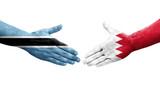 Handshake between Bahrain and Botswana flags painted on hands, isolated transparent image.