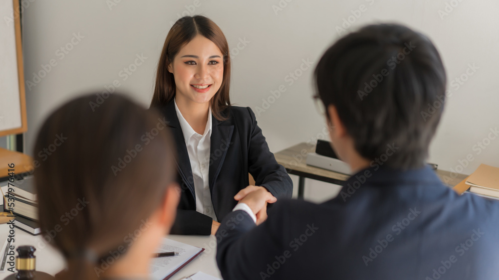Law and justice concept, Business team shaking hands with female lawyer after agreement contract Law and justice concept, Business team shaking hands with female lawyer after agreement contract