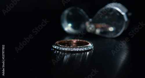 A diamond ring is a glittering wedding ring placed on the ground.