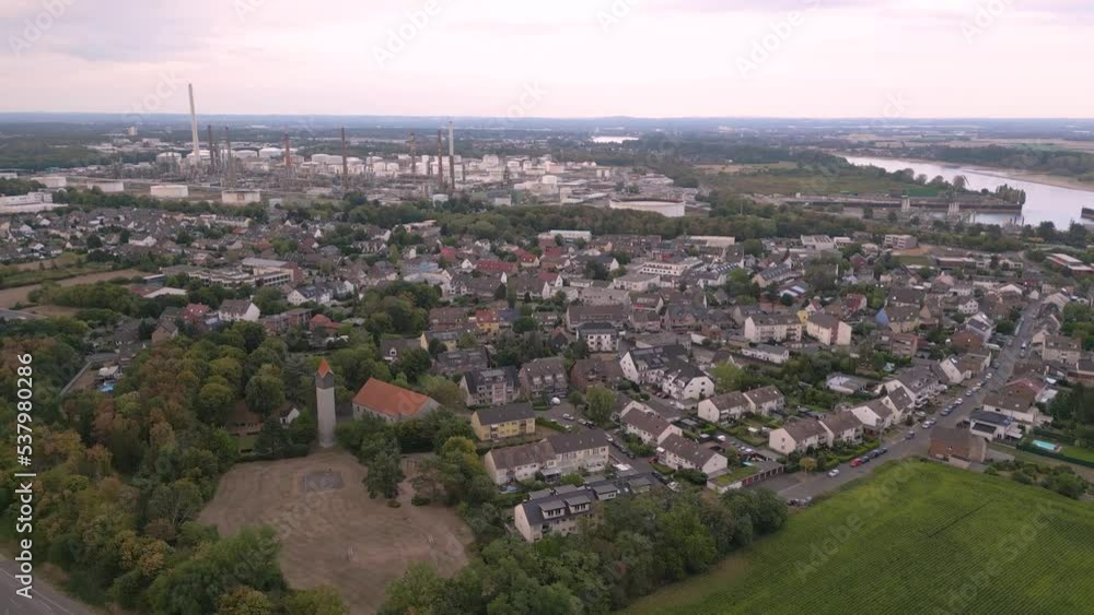 Aerial drone flyover the german city of Godorf in the south of Cologne, Germany - big industry chemical plant with chimneys storage oil and gas pipelines in the background next to the river Rhein 2022 Aerial drone flyover the german city of Godorf in the south of Cologne, Germany - big industry chemical plant with chimneys storage oil and gas pipelines in the background next to the river Rhein 2022