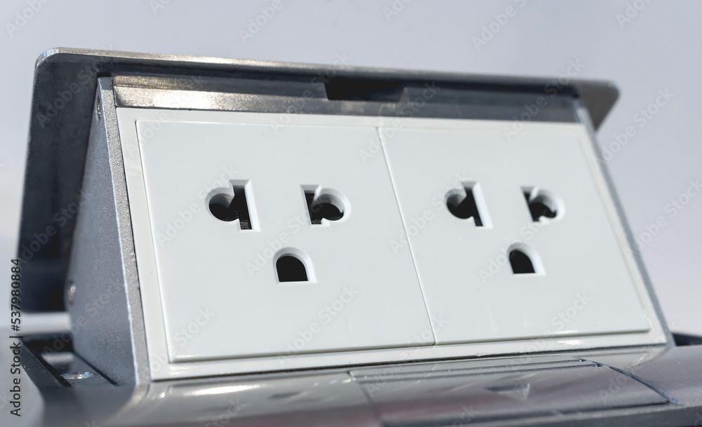 Closeup of a pop up floor socket with two universal outlets. Closeup of a pop up floor socket with two universal outlets.