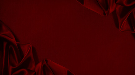 Black red silk satin. Beautiful soft folds. Shiny fabric.Dark luxury background with space for design. Christmas, Birthday, Valentine day, Valentine. Festive concept. Banner. Flat lay, Table top view.