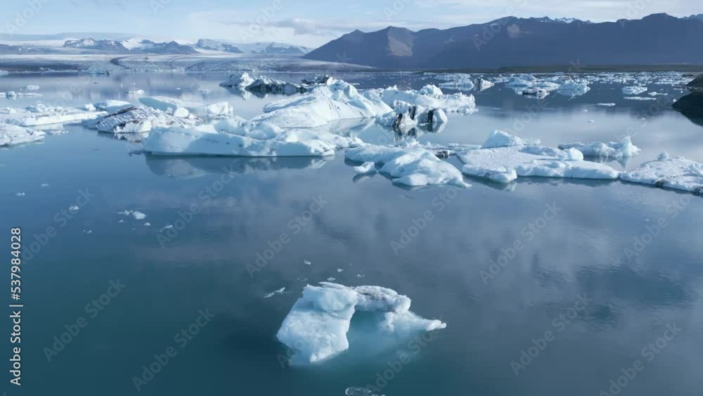 Icebergs Floating On The Waters Of Jokulsarlon Glacier Lagoon At Vatnajokull National Park In Iceland. aerial orbit Icebergs Floating On The Waters Of Jokulsarlon Glacier Lagoon At Vatnajokull National Park In Iceland. aerial orbit