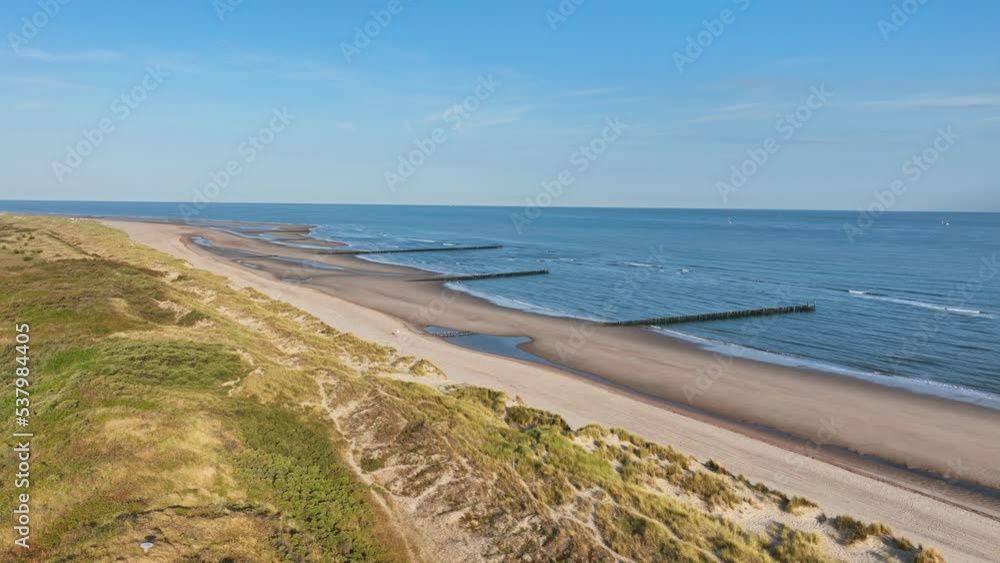 Nature reserves in the province of Zeeland, The Netherlands, Europe. Drone flying over sandy beach by the North Sea. Nature reserves in the province of Zeeland, The Netherlands, Europe. Drone flying over sandy beach by the North Sea.