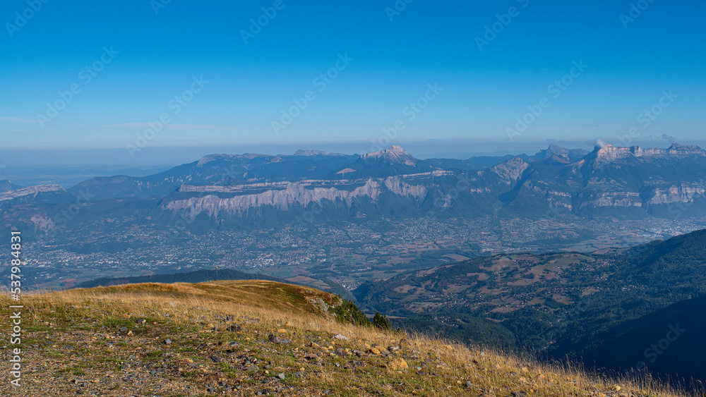 Valley with the city of Grenoble seen from the mountains of Chamrousse in summer in the Alps in France
