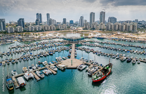 Ashdod city complete beautiful panoramic aerial view from the sea showing it modern marina symmetric open landscape and sky scrapers in the distance with overcast skies
