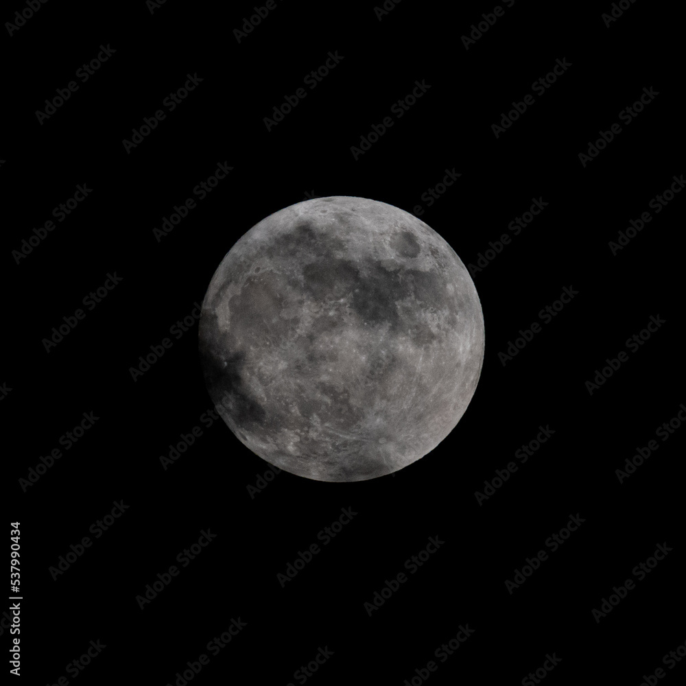 Isolated close up of the full moon with light cloud cover Isolated close up of the full moon with light cloud cover